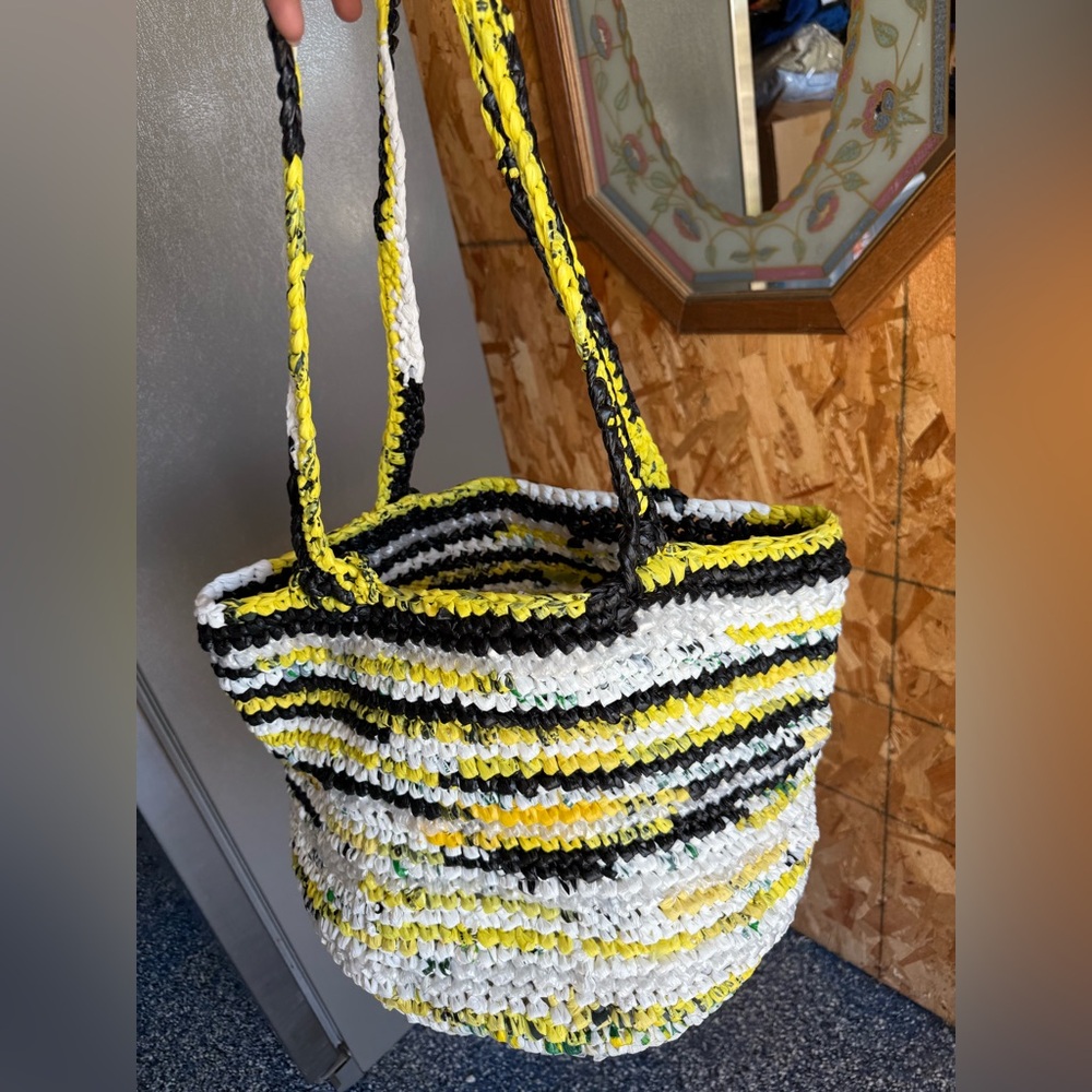 Handmade from plastic bags crocheted shopping tote bag with a pocket